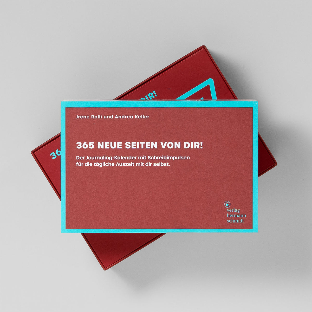 Kartenblock des Journaling-Kalenders 365 neue Seiten von dir 2027 liegt gedreht auf der roten Box