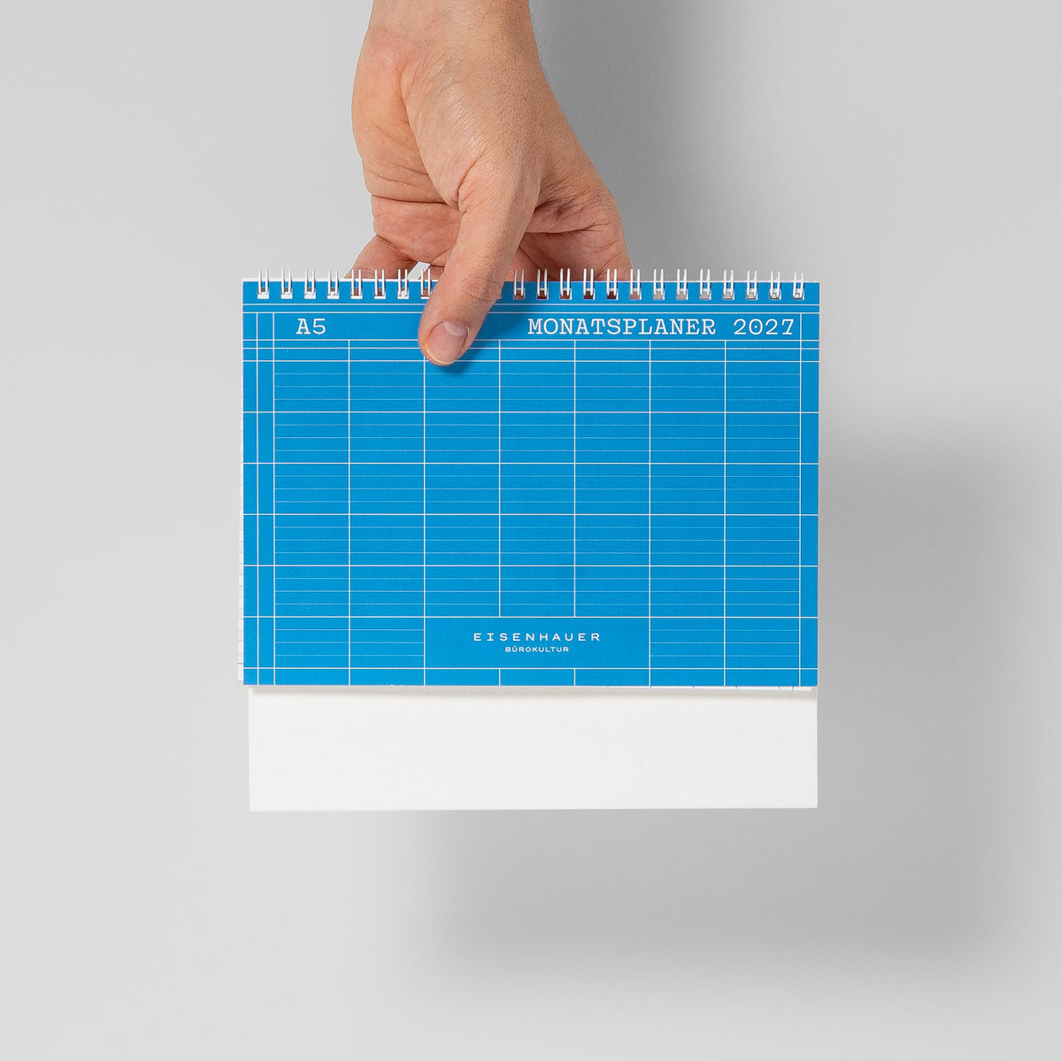 A5 Tischkalender 2027 im Größenvergleich, von einer Hand gehalten